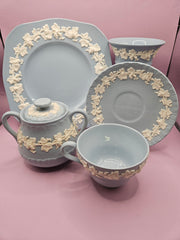 Vintage 1950's Wedgwood Queensware cream on lavender tableware, including tea cup and saucer, sugar bowl, creamer, dessert plate, ashtray, and vase with embossed floral detailing, perfect for elegant dining and collectible decor