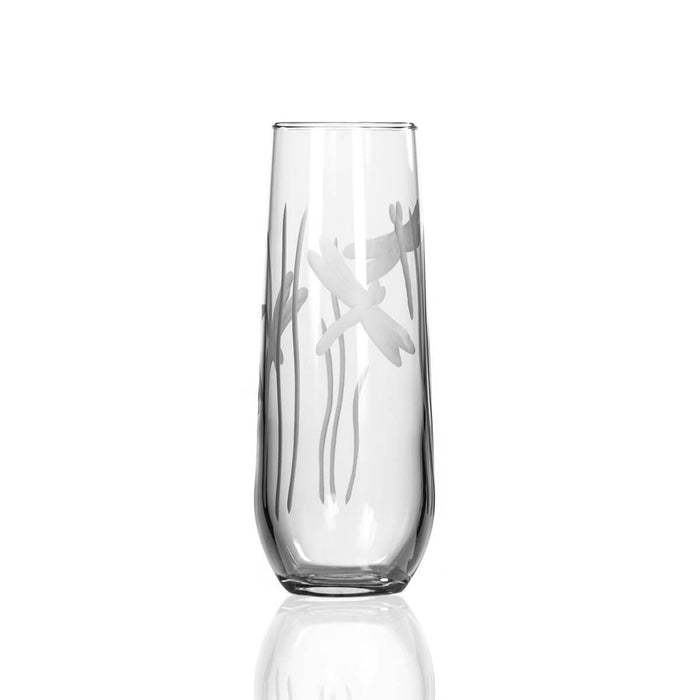 Close-up of dragonfly-etched stemless champagne flute glass with detailed engraving.