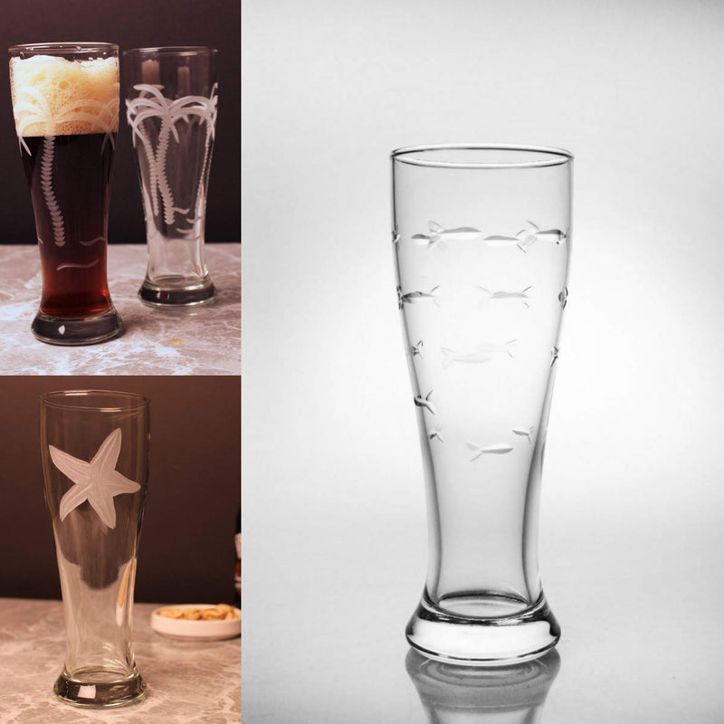 Collage of etched pilsner glasses featuring various designs including palm trees, starfish, and a school of fish. The glasses have a tall, sleek design with heavy bottoms, perfect for enjoying beer in style.