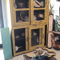 Rustic farmhouse style teak cabinet in bold yellow finish with patina