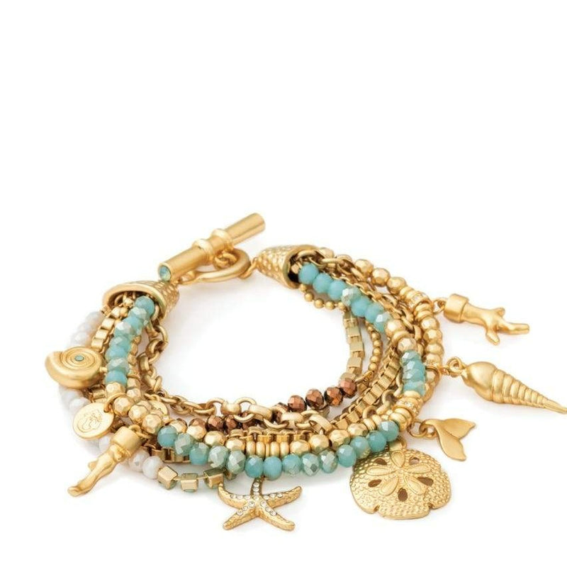 A close-up view of the Washed Ashore Beaded Toggle Bracelet showcasing gold-plated seaside charms, turquoise and gold beads, and a toggle clasp.